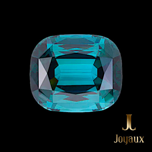  The 28.05-Carat Indicolite Tourmaline from Joyaux™ Genève embodies the very essence of this legendary terrain, capturing the mystique and majesty of its origins. With dimensions of 19.70 x 16.60 x 11.10 mm, this rectangular cushion-cut gem radiates a greenish-blue hue reminiscent of the tranquil depths of hidden mountain lakes. 